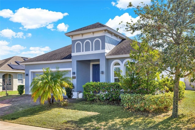 view of front facade with a garage and a front yard