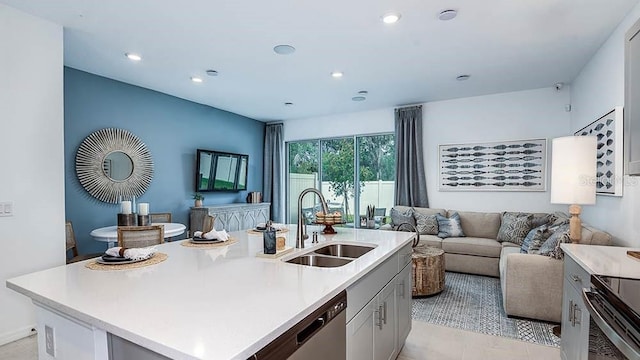 kitchen featuring appliances with stainless steel finishes, sink, and a center island with sink