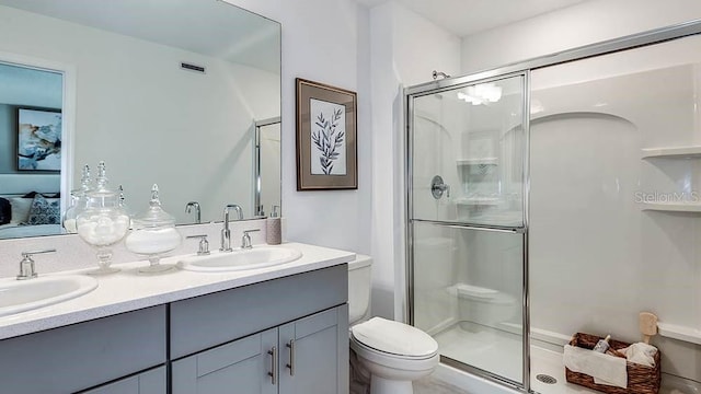 bathroom featuring walk in shower, vanity, and toilet