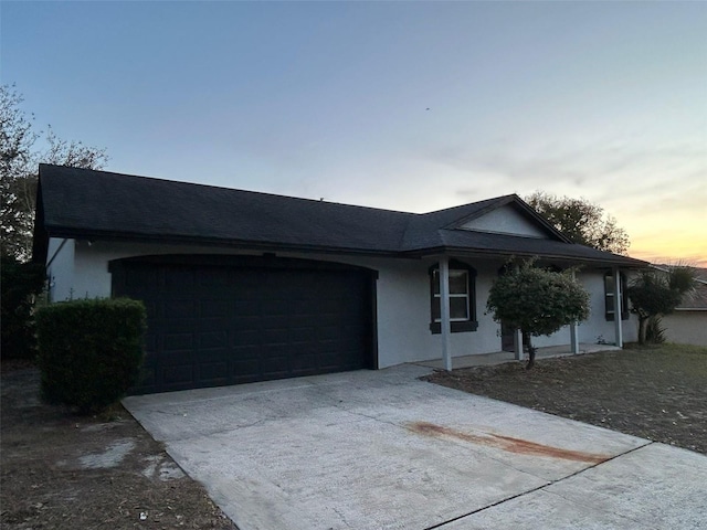 ranch-style house featuring a garage