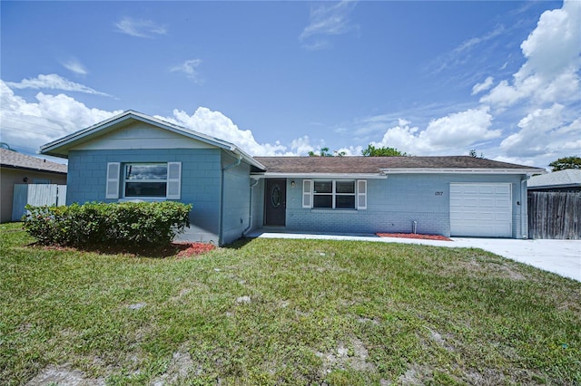 single story home featuring a garage and a front lawn