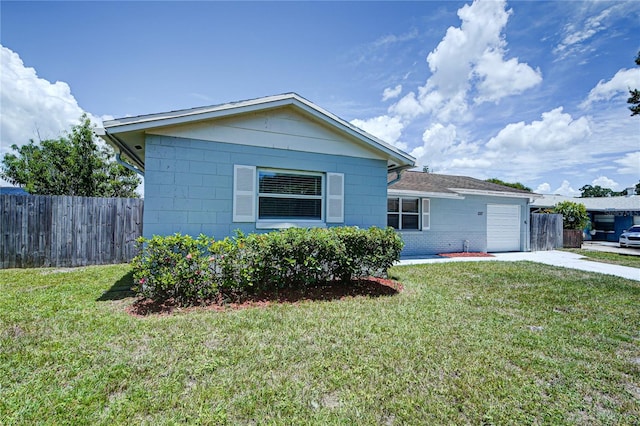 view of front of home featuring a garage and a front lawn