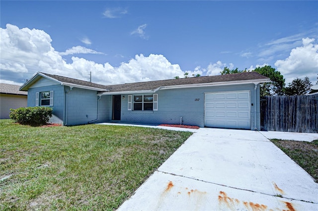 ranch-style home with a garage and a front lawn