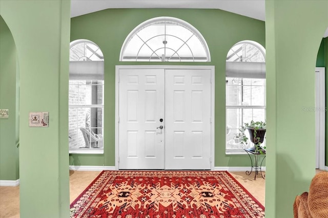 entryway featuring plenty of natural light and vaulted ceiling