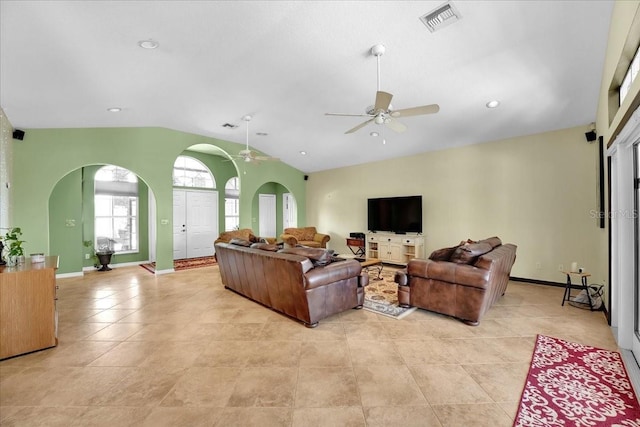 living room featuring ceiling fan, vaulted ceiling, and light tile patterned floors