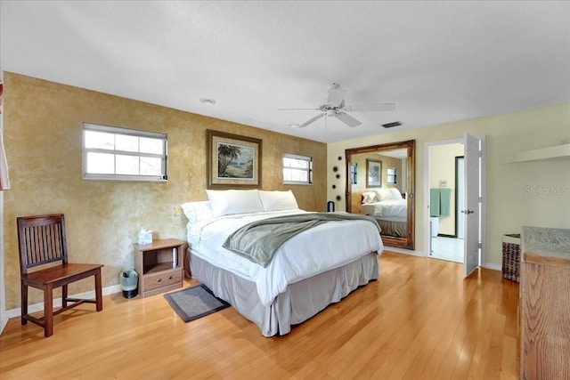 bedroom featuring multiple windows, ceiling fan, and light wood-type flooring