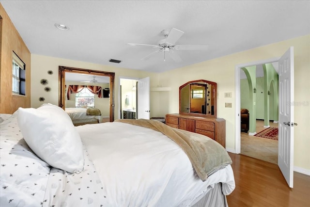 bedroom with ceiling fan and light wood-type flooring