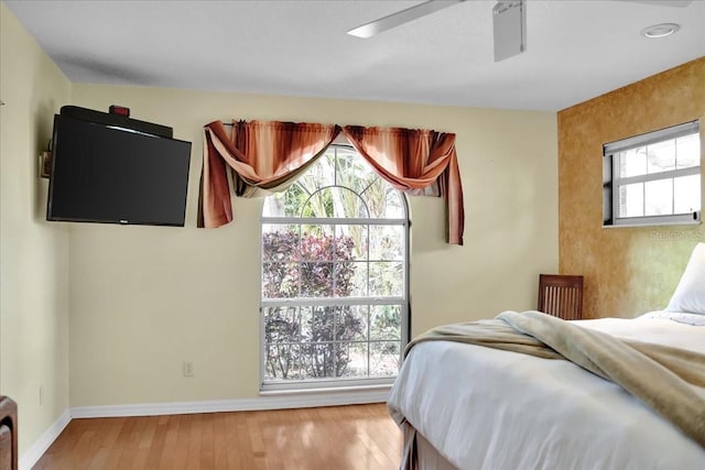 bedroom with ceiling fan and light wood-type flooring