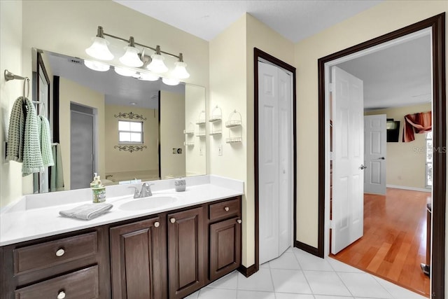 bathroom featuring tile patterned flooring and vanity