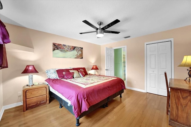 bedroom featuring ceiling fan, wood-type flooring, and a closet