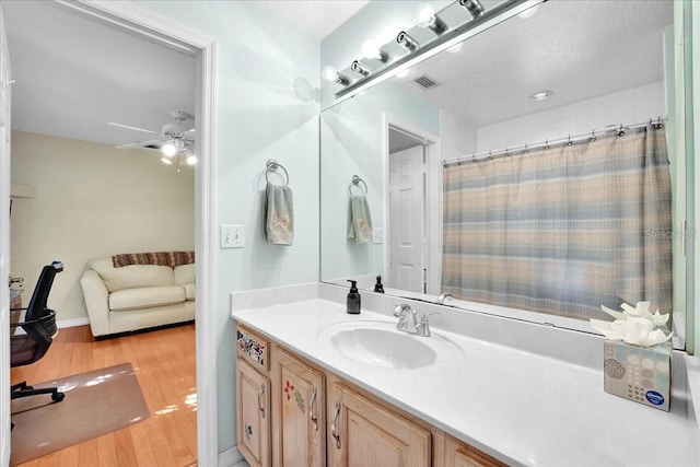 bathroom with vanity, hardwood / wood-style floors, and ceiling fan