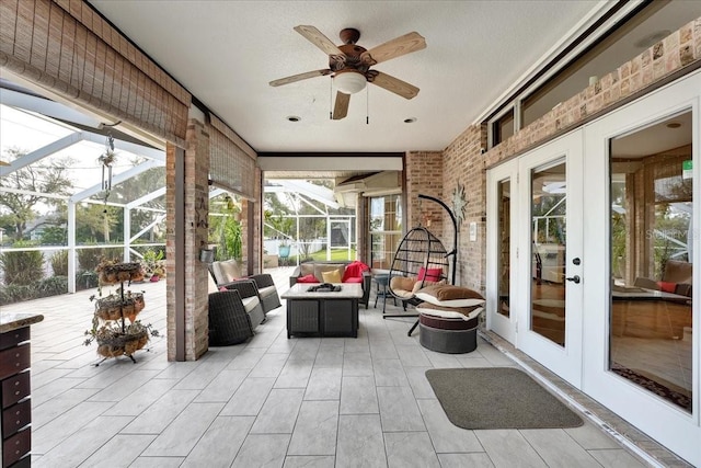 sunroom / solarium featuring french doors and ceiling fan