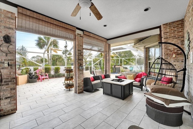 sunroom / solarium featuring ceiling fan