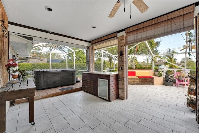 unfurnished sunroom with plenty of natural light and ceiling fan