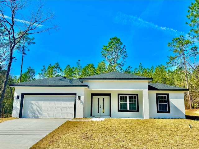 view of front facade with a garage and a front lawn