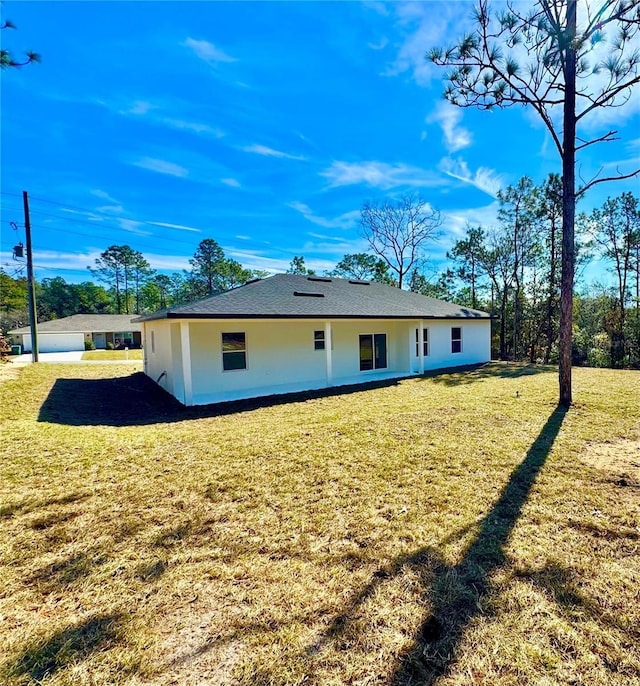 back of house featuring a yard