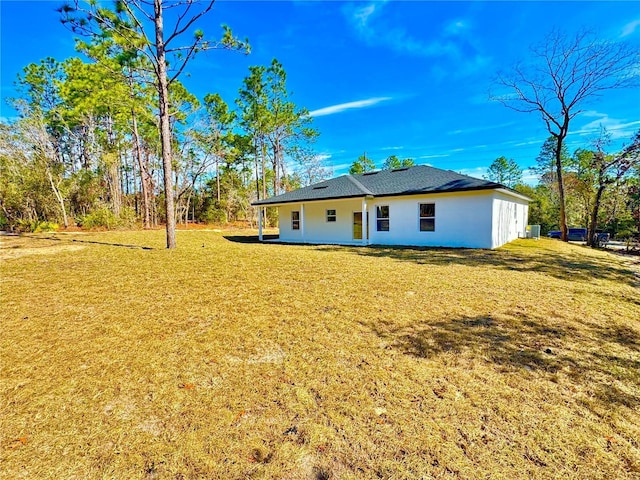 back of house with a lawn