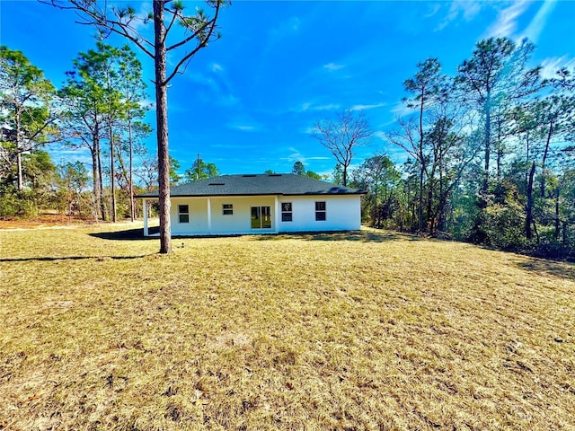 back of house with a yard