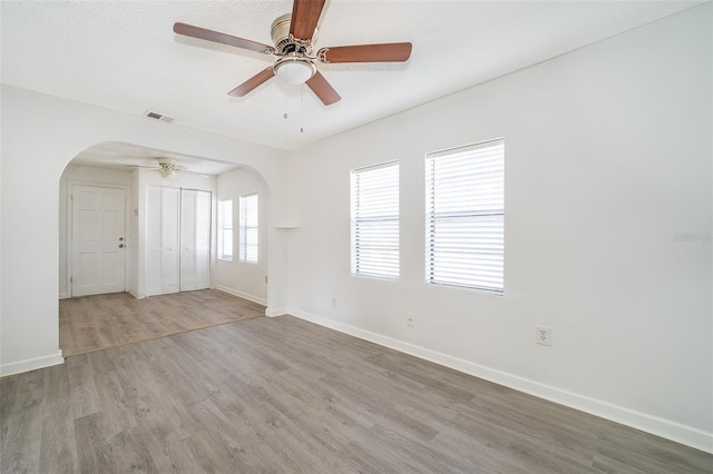 empty room with light hardwood / wood-style flooring and ceiling fan