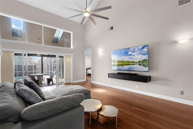 living room featuring hardwood / wood-style flooring and high vaulted ceiling