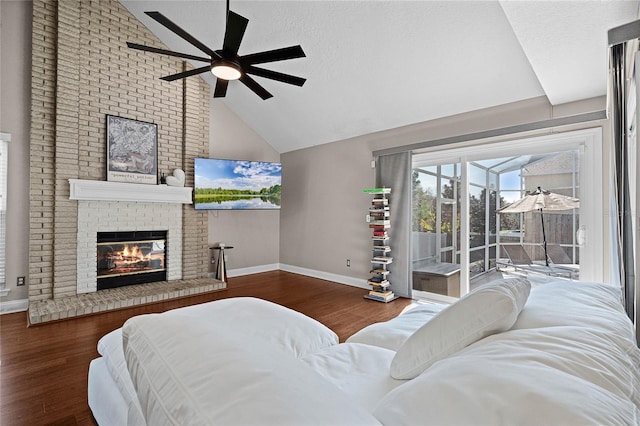 bedroom featuring a fireplace, access to exterior, ceiling fan, dark wood-type flooring, and a textured ceiling