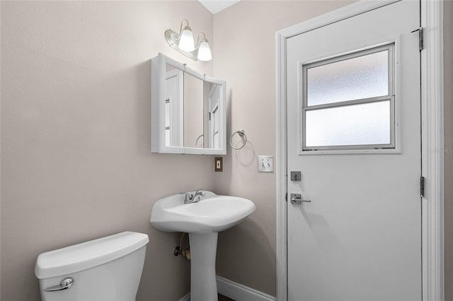 bathroom featuring toilet and sink