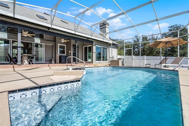 view of pool featuring a patio, ceiling fan, and glass enclosure