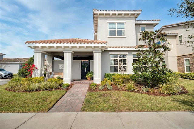 mediterranean / spanish house featuring a front yard