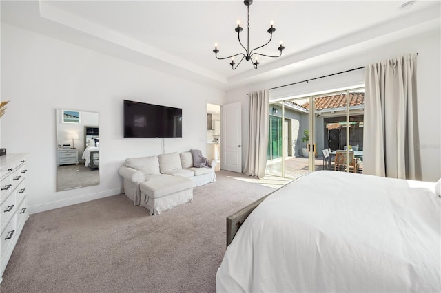 bedroom with an inviting chandelier, access to exterior, light colored carpet, and a raised ceiling