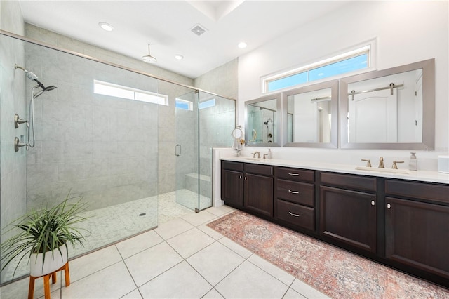 bathroom featuring tile patterned floors, vanity, and an enclosed shower