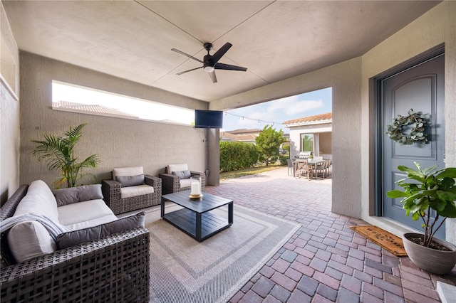 view of patio / terrace featuring ceiling fan and an outdoor living space