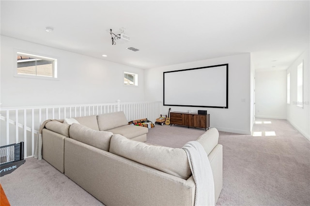 carpeted home theater with plenty of natural light