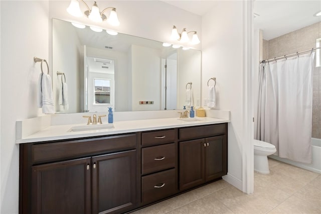 full bathroom featuring shower / tub combo with curtain, tile patterned flooring, vanity, toilet, and a chandelier