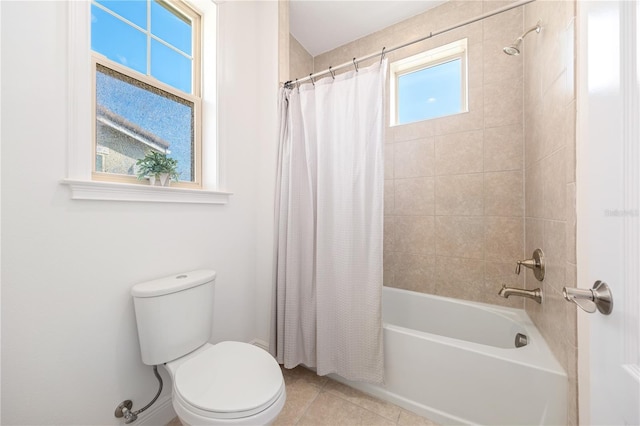 bathroom featuring a wealth of natural light, shower / tub combo with curtain, tile patterned floors, and toilet