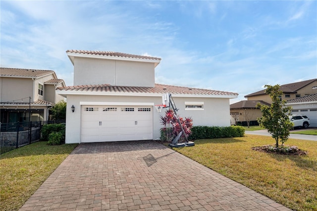 mediterranean / spanish-style home featuring a garage and a front yard