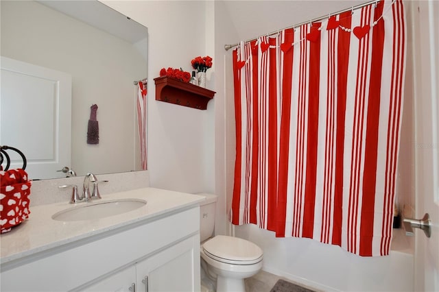 full bathroom featuring vanity, shower / tub combo, and toilet