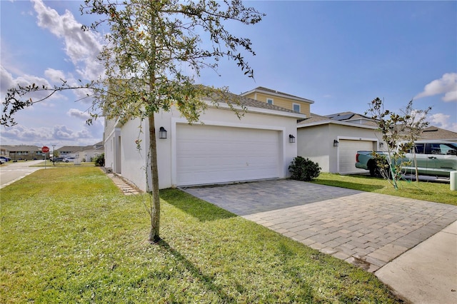 view of front of house with a garage and a front yard