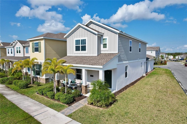 2429 Volunteer Ave, Kissimmee, FL 34744 - view of front of property with a residential view, outdoor lounge area, a front lawn, board and batten siding, and roof with shingles