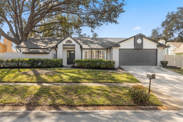 ranch-style home with a garage and a front yard