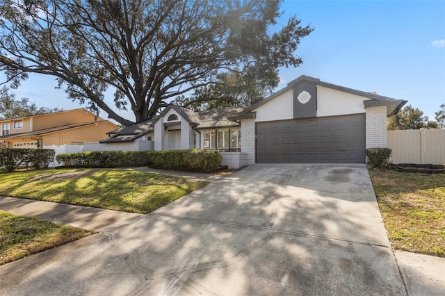 single story home with a garage and a front lawn