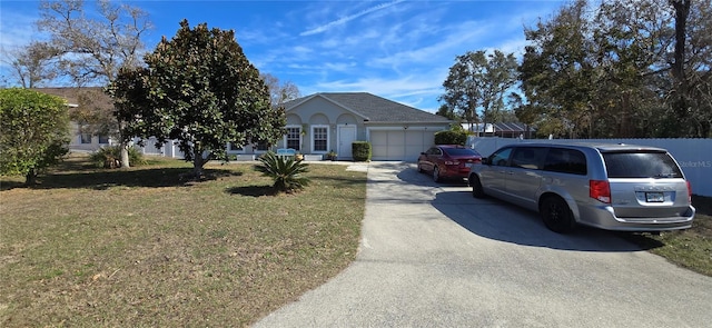 view of front facade with a garage and a front yard