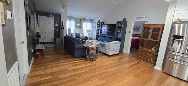 living room with lofted ceiling and light wood-type flooring