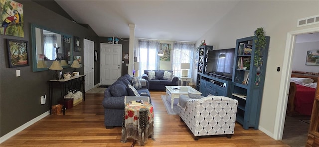 living room featuring hardwood / wood-style floors and vaulted ceiling