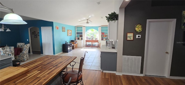 kitchen featuring pendant lighting, ceiling fan, gray cabinets, and light wood-type flooring