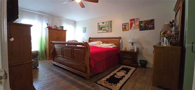 bedroom with dark hardwood / wood-style floors and ceiling fan