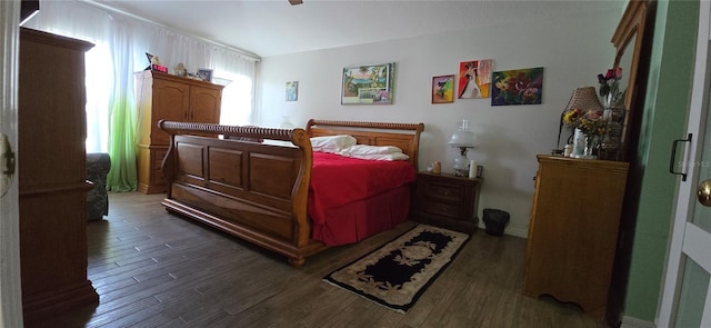 bedroom with dark hardwood / wood-style floors