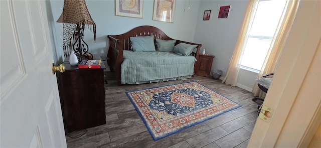 bedroom with dark hardwood / wood-style flooring