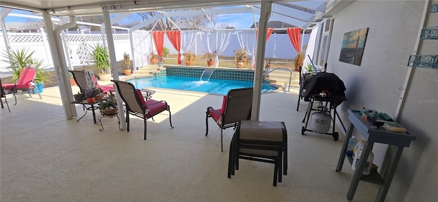 view of swimming pool with a patio area, pool water feature, and glass enclosure