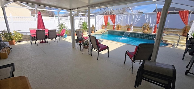 view of pool with a patio, a lanai, and pool water feature