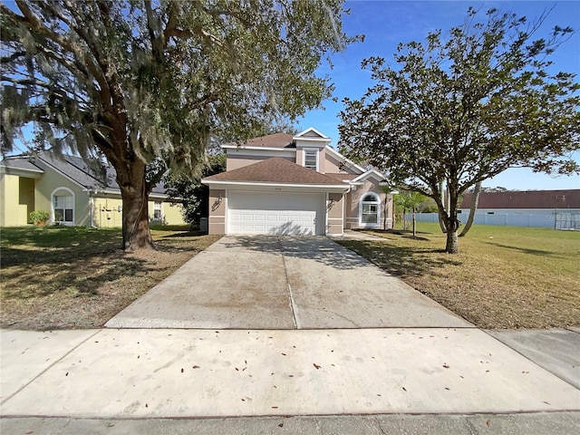 view of front of property featuring a garage and a front lawn